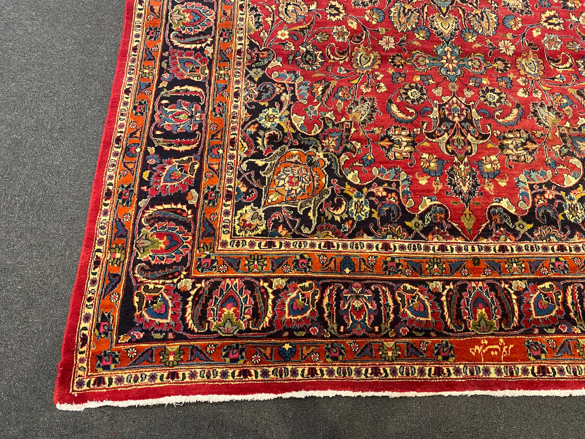 A Kashan claret ground carpet, 375cm x 250cm